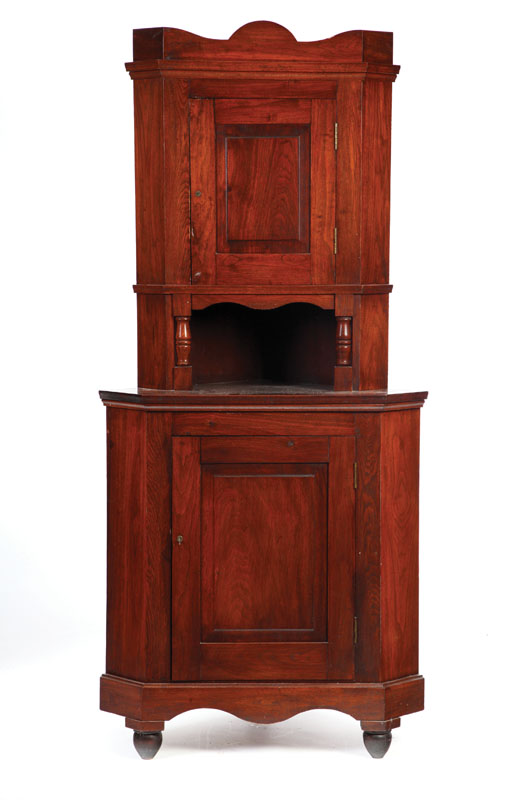 Appraisal: SMALL ONE PIECE CORNER CUPBOARD Walnut with a shaped crest