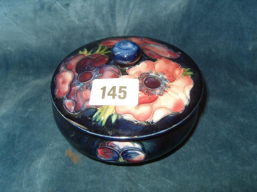 Appraisal: A Moorcroft powder bowl and cover with pink and red