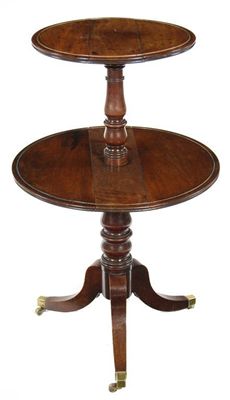 Appraisal: A George III mahogany dumb waiter having two dished folding