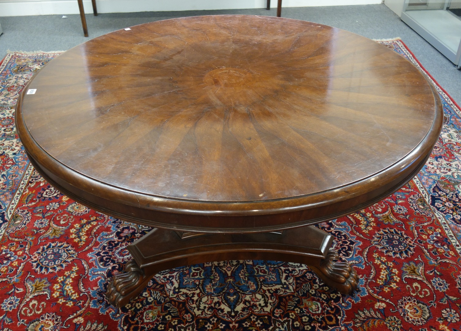 Appraisal: An early Victorian circular mahogany snap top table on concave