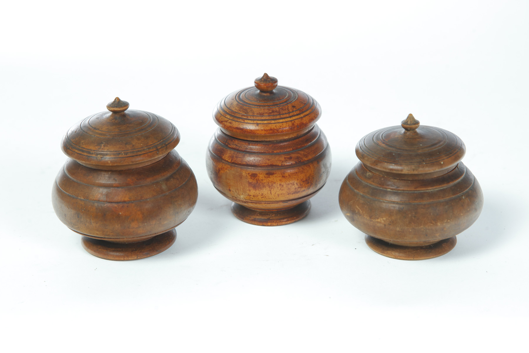 Appraisal: THREE OHIO PEASEWARE COVERED CONTAINERS Late th century Treenware with