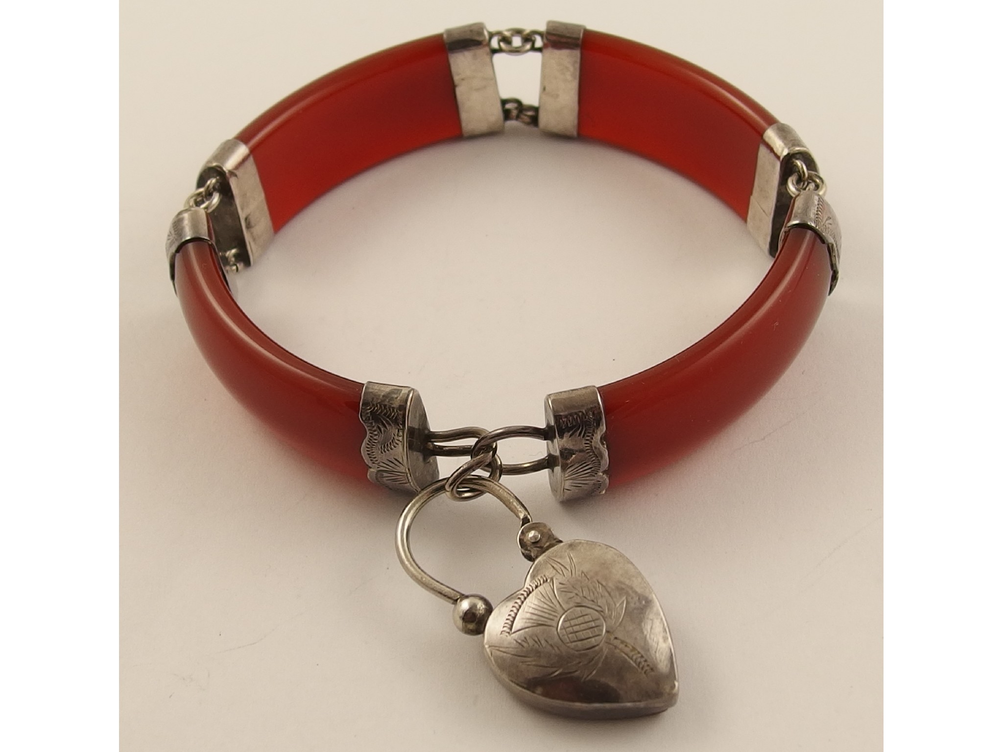 Appraisal: A Scottish white metal and agate braceletthe shaped red agate