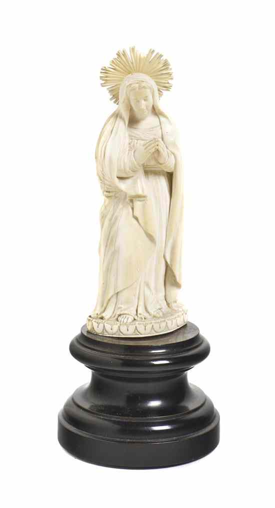 Appraisal: A Continental Carved Ivory Figure depicting the Madonna raised on