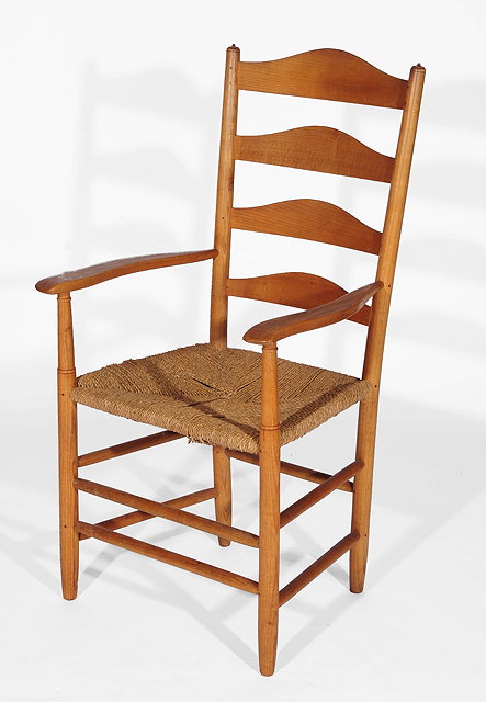 Appraisal: A Cotswold style armchairwith ladder back and curved open arms