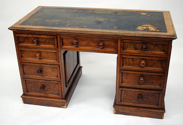 Appraisal: A VICTORIAN WALNUT PEDESTAL DESK with the remains of a