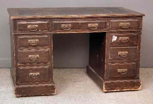 Appraisal: A late Victorian dark oak kneehole desk fitted nine drawers