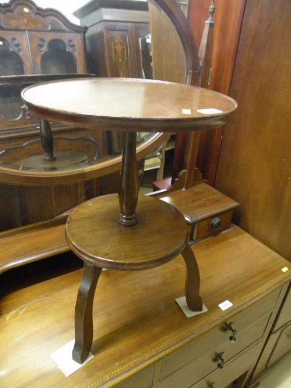 Appraisal: A Victorian mahogany two tier what-not with a circular column