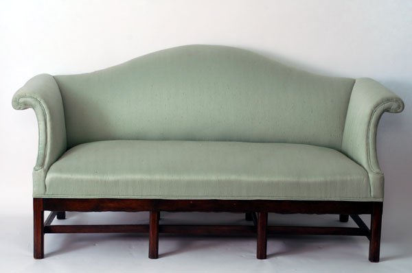 Appraisal: Chippendale style settee humpback with rolled arms and green upholstery