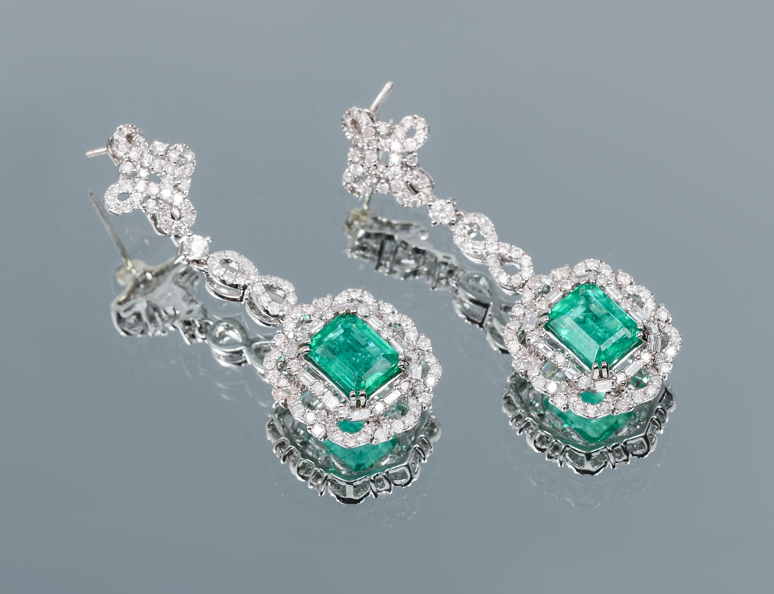 Appraisal: K CTW EMERALD DIAMOND DANGLE EARRINGS Each earring is prong