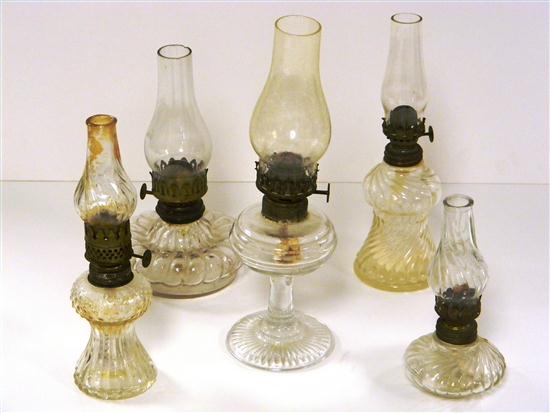 Appraisal: Five colorless pressed glass oil lamps various sizes and shapes