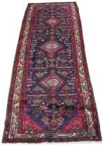 Appraisal: A Baktiari Carpet A geometric runner with three diamond cartouches