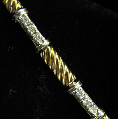 Appraisal: DIAMOND AND FOURTEEN KARAT WHITE AND YELLOW GOLD LINE BRACELET