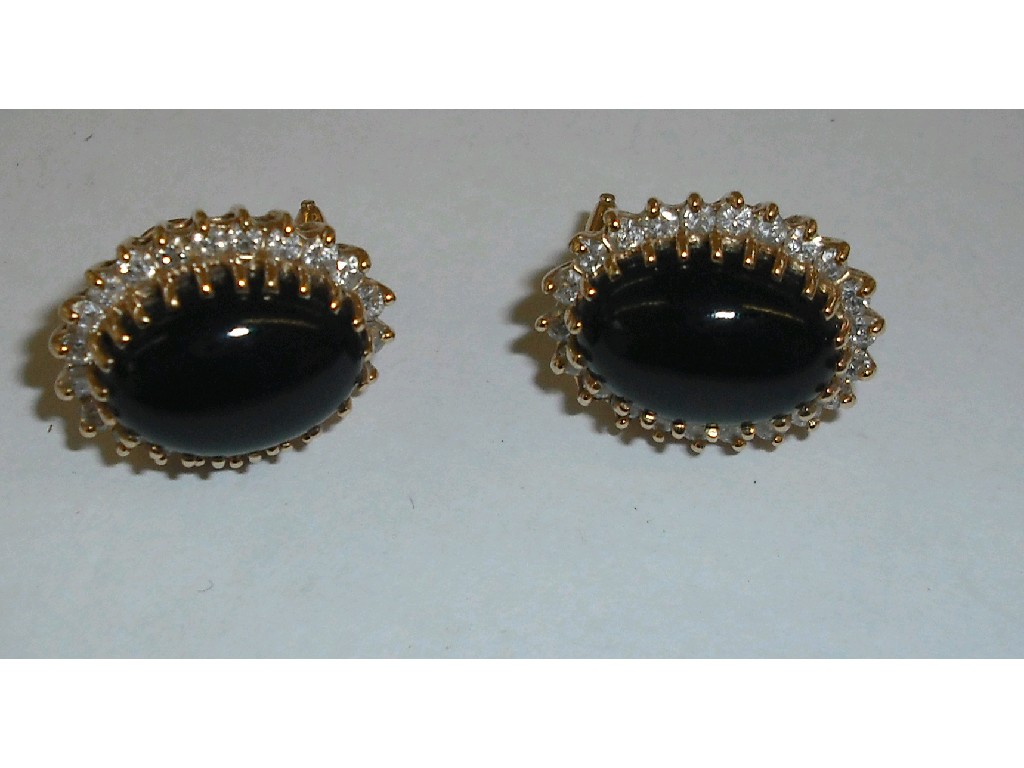 Appraisal: Pair of ct diamond and onyx oval cluster earrings gm