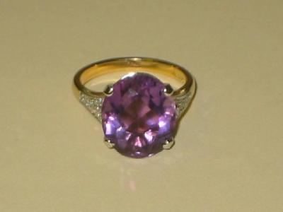 Appraisal: AN AMETHYST AND DIAMOND DRESS RING the oval-cut amethyst claw