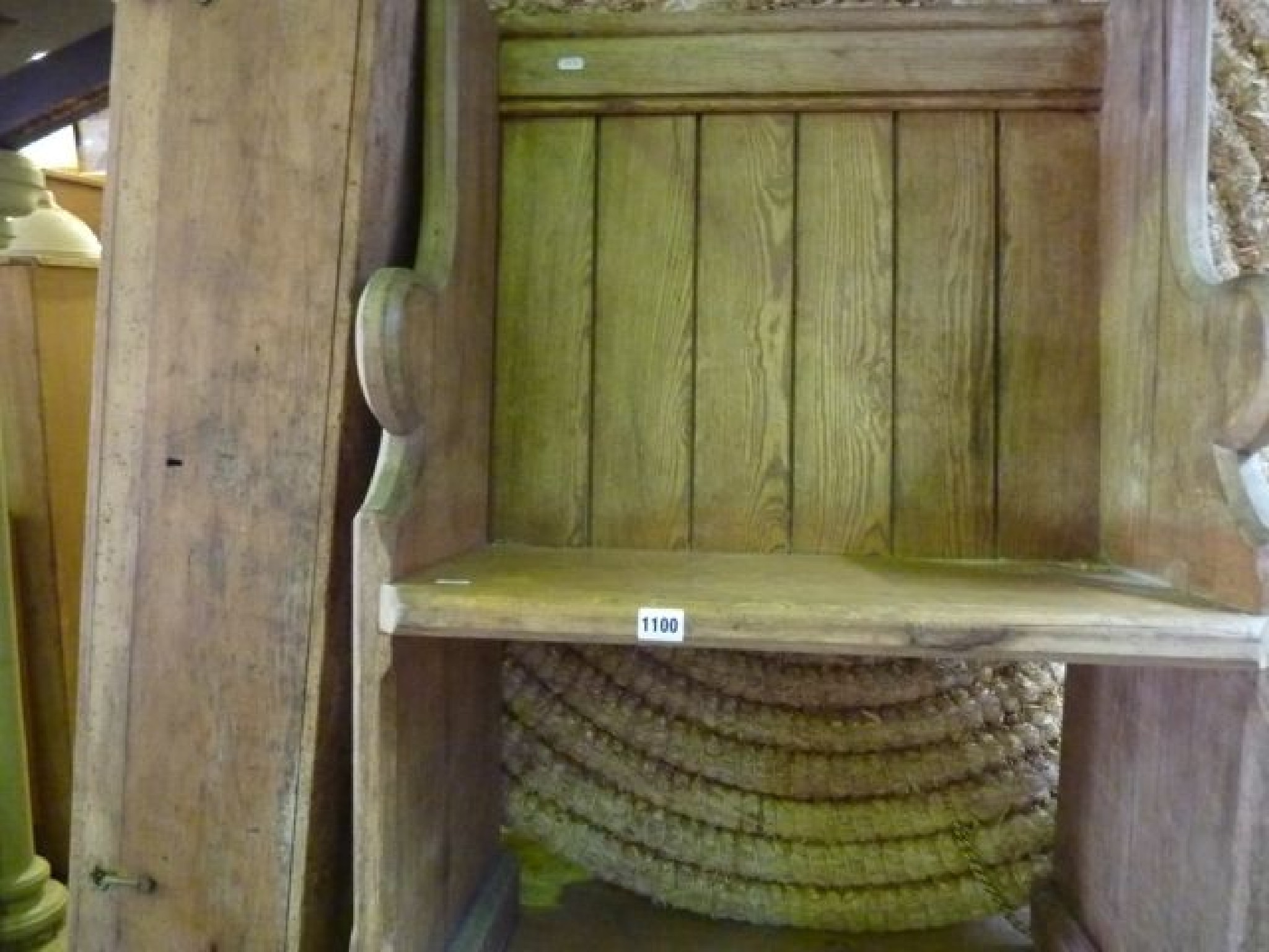 Appraisal: A small pitch pine pew seat with chamfered and shaped