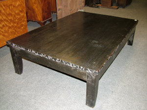 Appraisal: A carved ebonised low table of rectangular form upon square