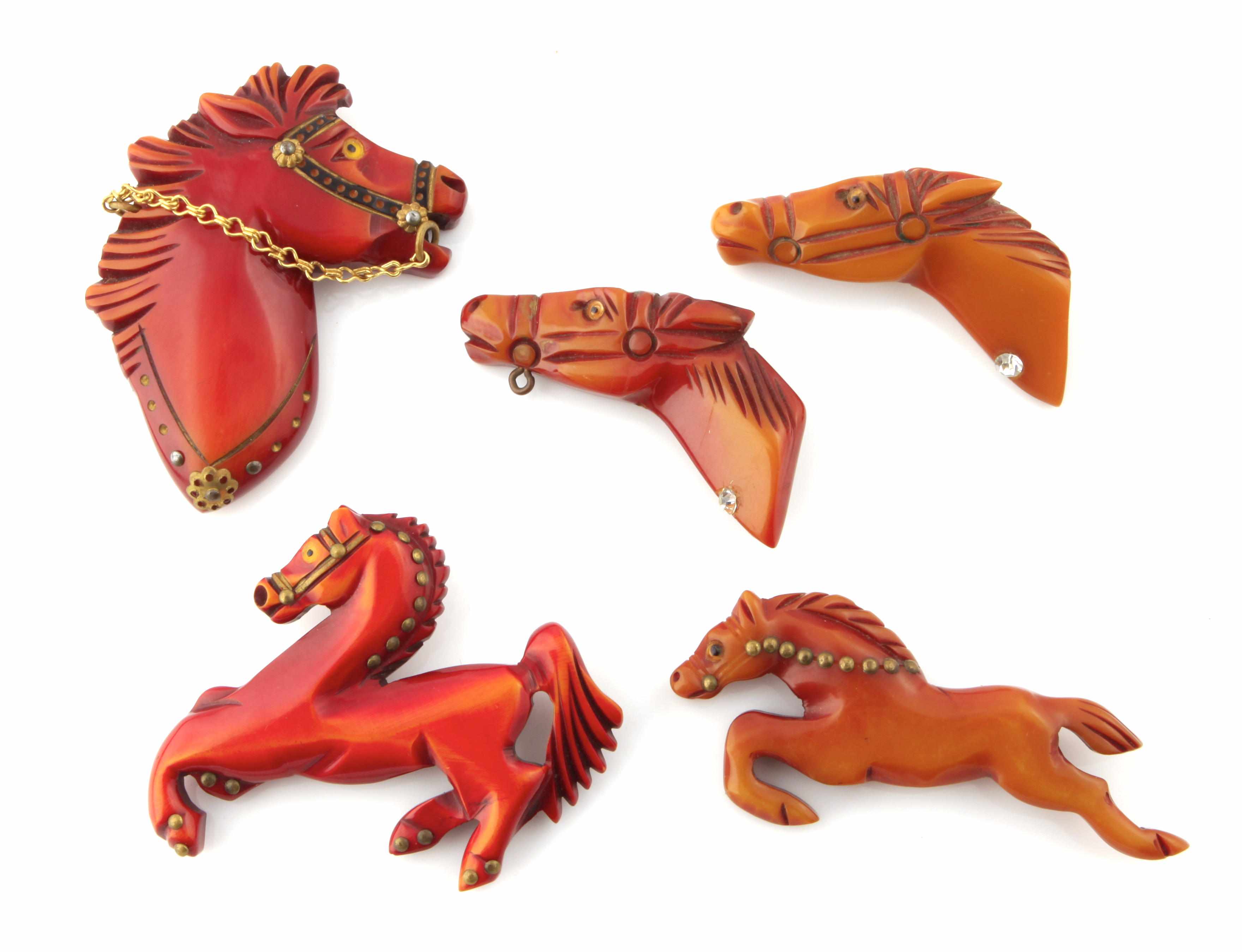 Appraisal: Five carved Bakelite horse brooches three painted