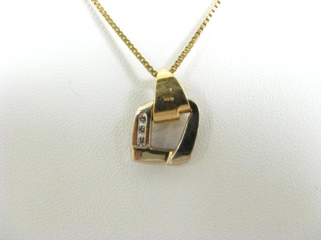 Appraisal: K yellow gold pendant with three channel mounted accent diamonds