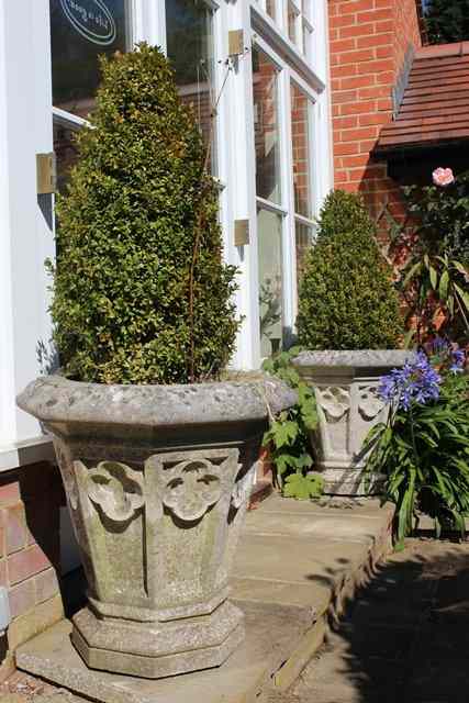 Appraisal: A PAIR OF HADDONSTONE OCTAGONAL GOTHIC STYLE VASE PLANTERS with