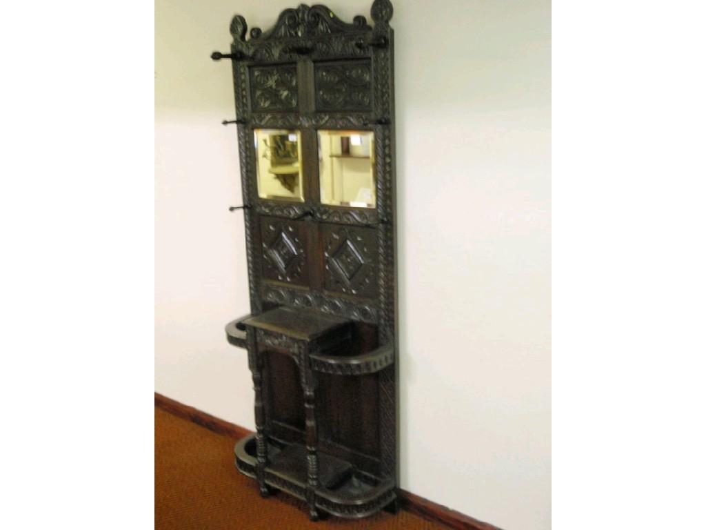 Appraisal: A Victorian carved oak hall stand with inset panels bevel