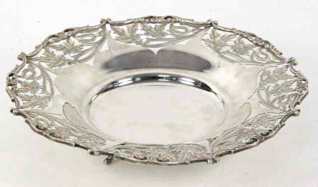 Appraisal: An Egyptian white metal dish with pierced border on three