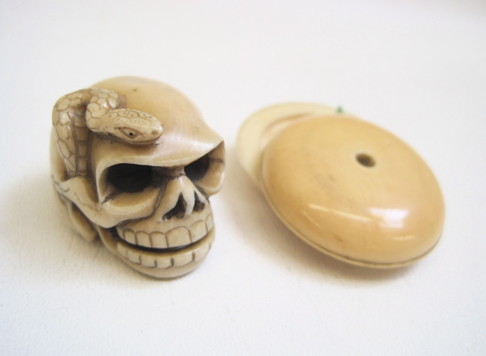 Appraisal: TWO HAND CARVED IVORY PIECES A diameter button separates for