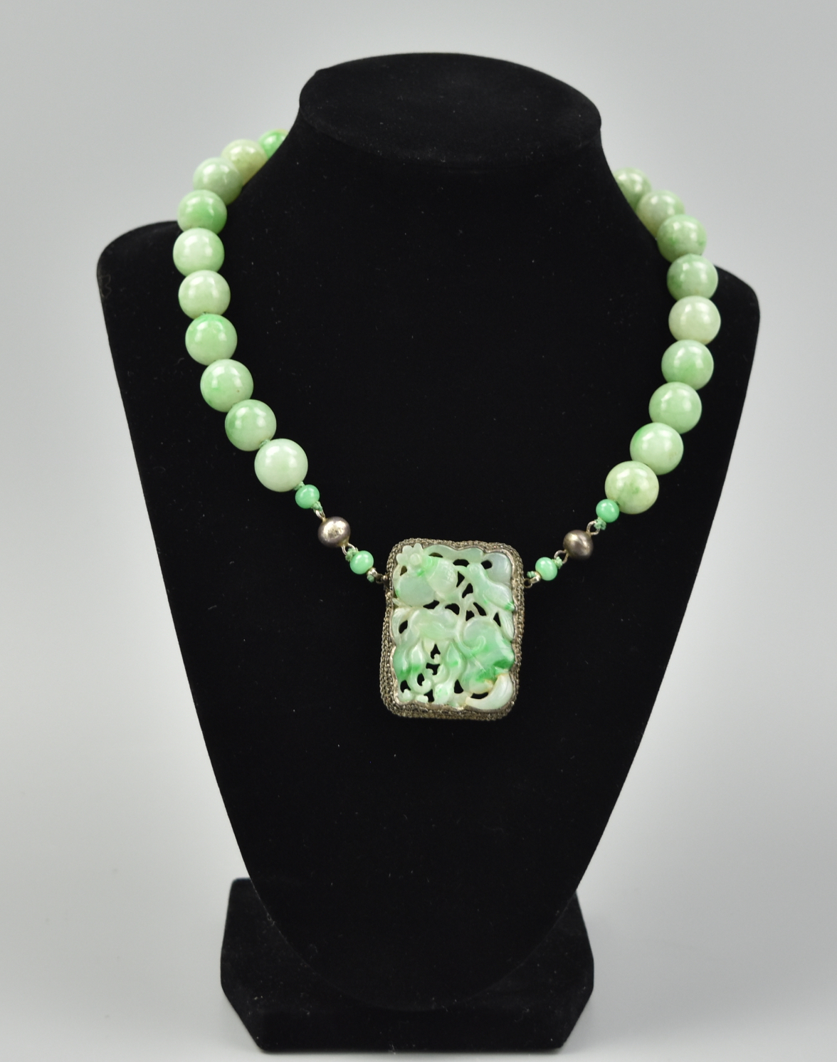 Appraisal: CHINESE BEADED JADEITE SILVER NECKLACE QING D A green jadeite