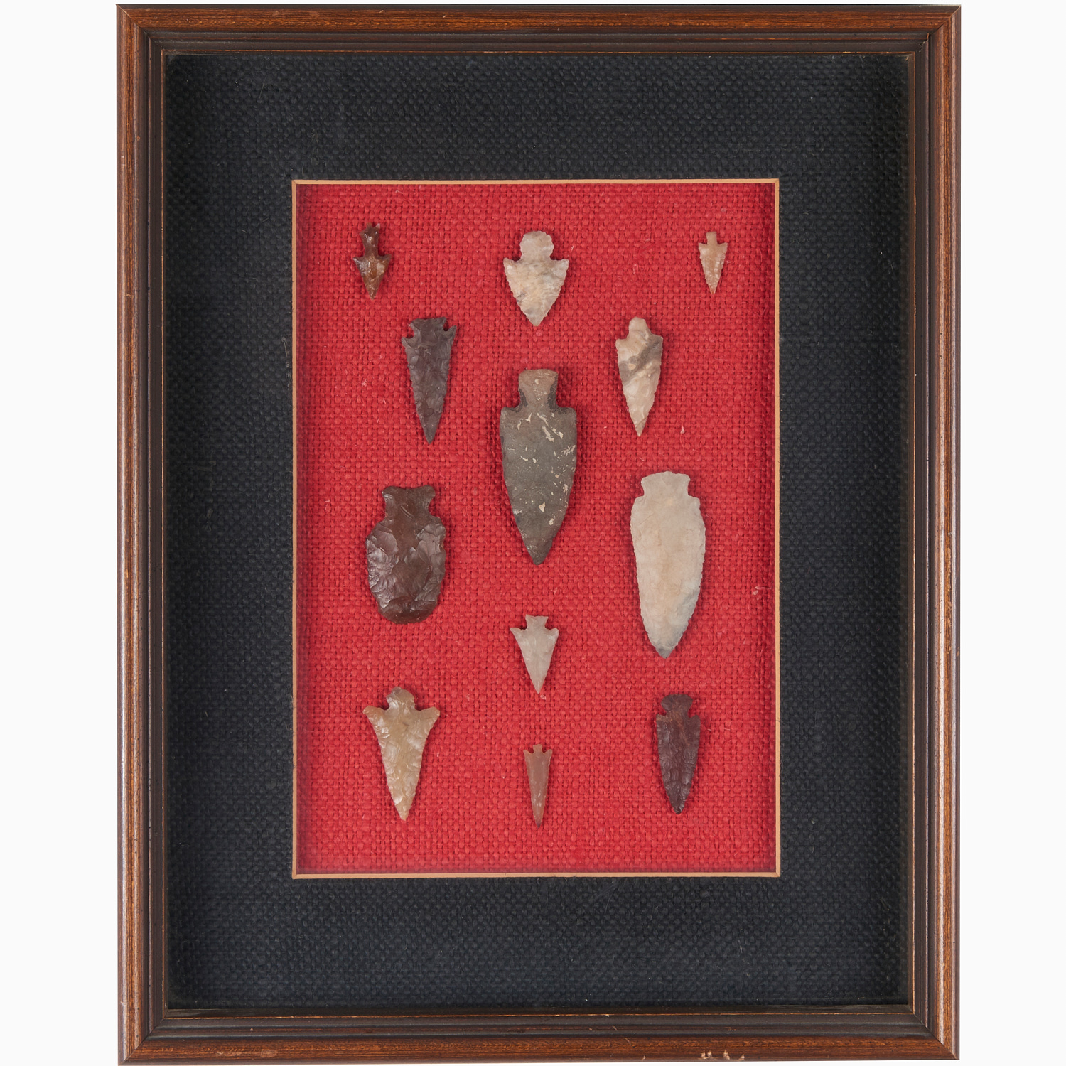 Appraisal: INDIAN STONE PROJECTILE POINTS IN DISPLAY Arrowheads mounted and framed