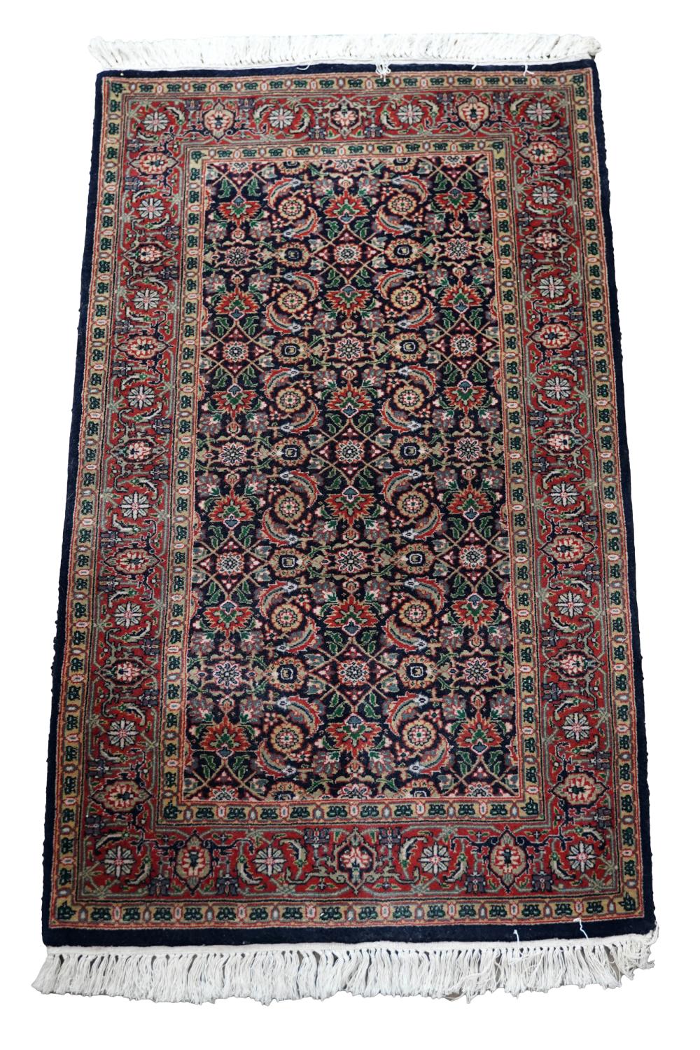 Appraisal: PERSIAN CARPETwool red and dark blue field ' x '