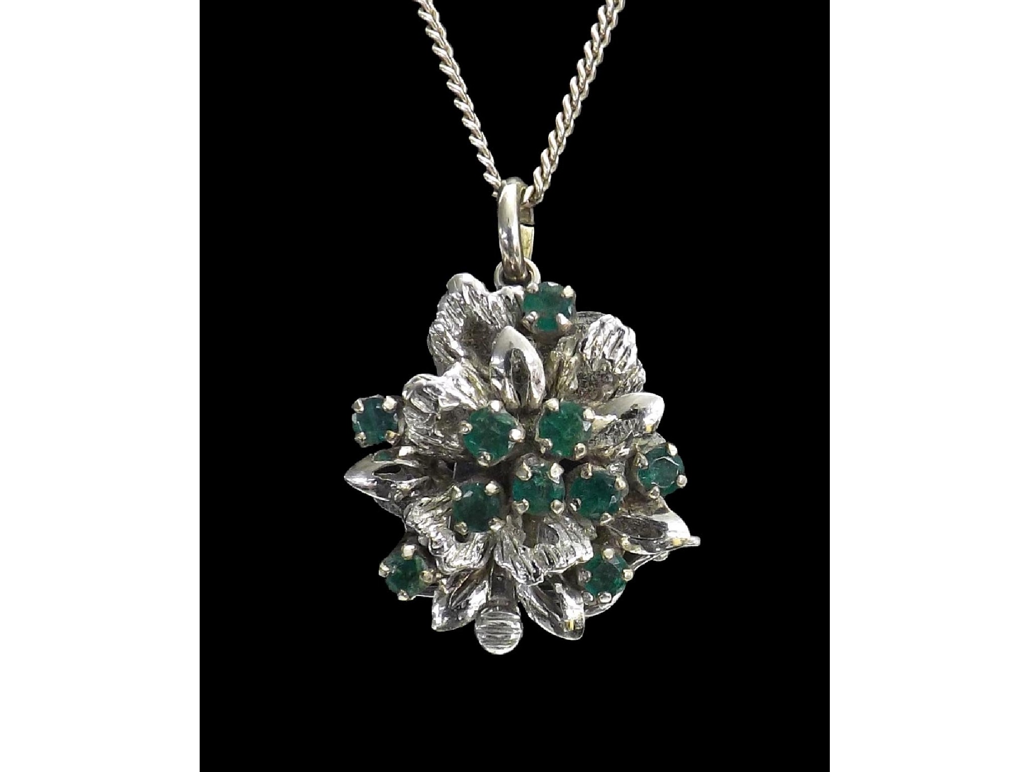 Appraisal: k white gold emerald floral pendant on a slender silver