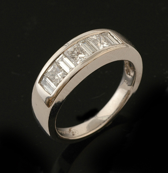 Appraisal: A diamond eternity ring The tapered platinum band channel set