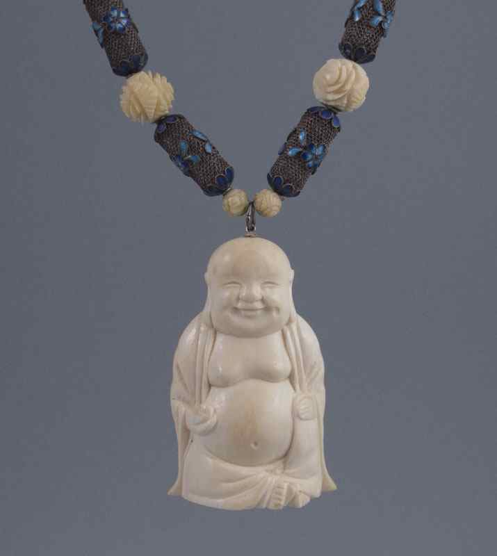 Appraisal: CARVED IVORY BUDDHA NECKLACE Cloisonne and fine pierce work beads