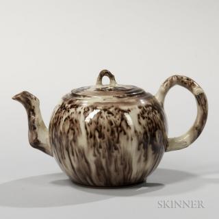 Appraisal: Brown Tortoiseshell-glazed Cream-colored Earthenware Teapot and Cover England c globular