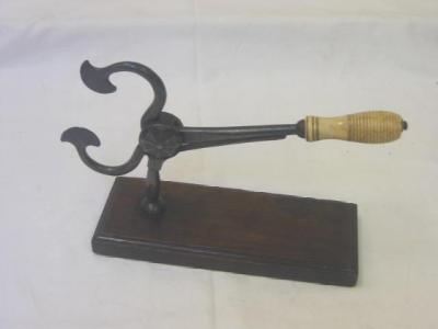 Appraisal: A PAIR OF IRON SUGAR CUTTERS mounted on oblong mahogany