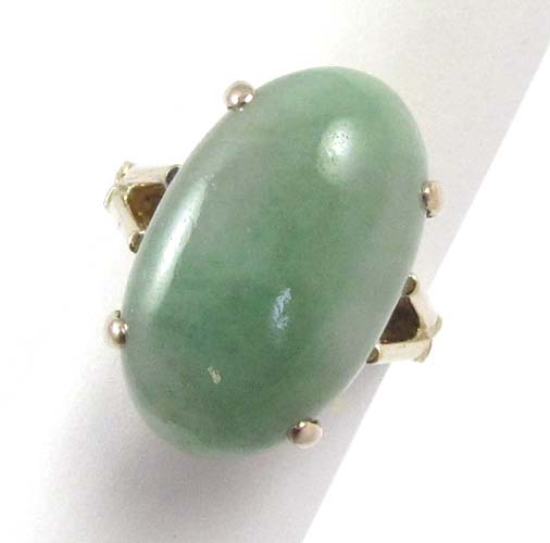 Appraisal: JADE AND EIGHTEEN KARAT GOLD RING Four yellow gold prongs