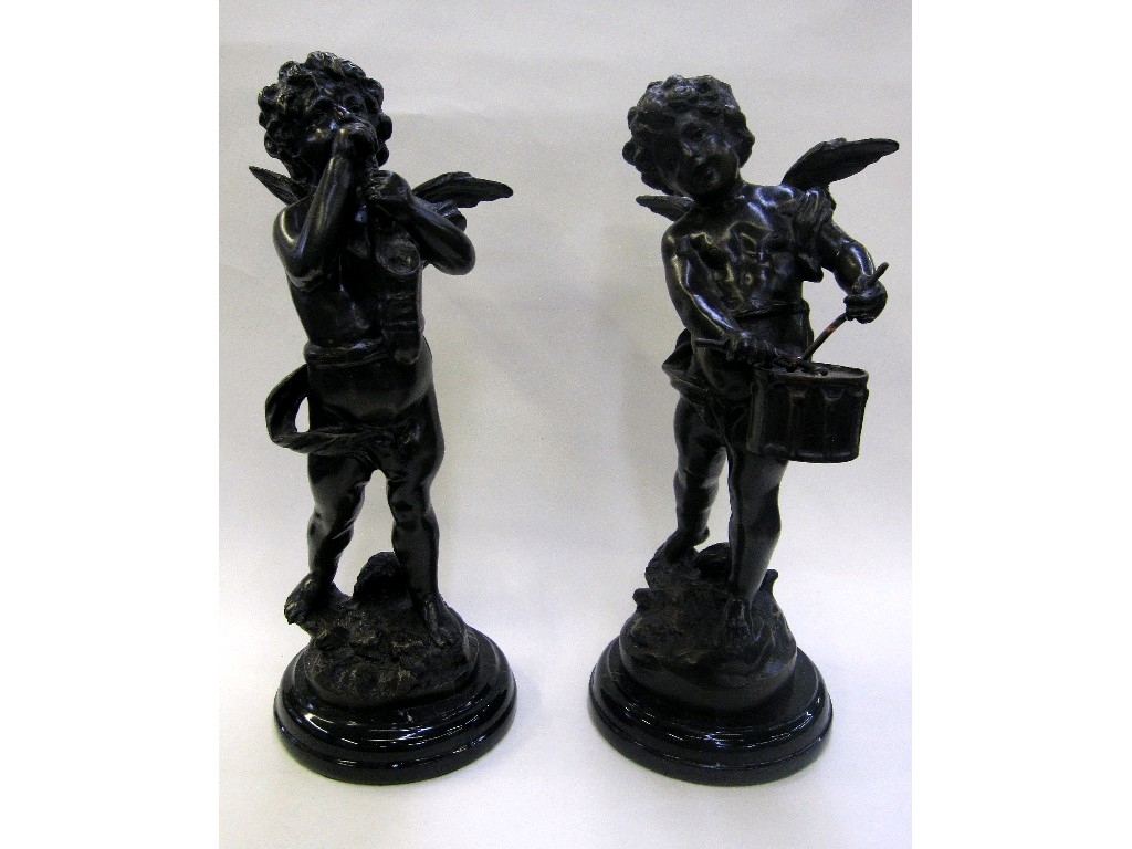 Appraisal: Pair of bronzed metal figures of cherubs playing instruments