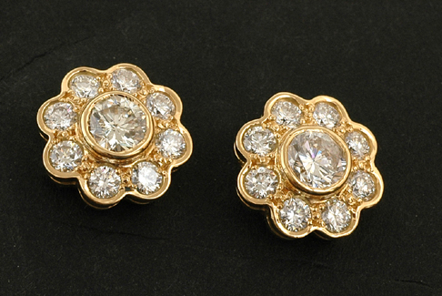 Appraisal: A pair of diamond flower cluster earrings Each having a