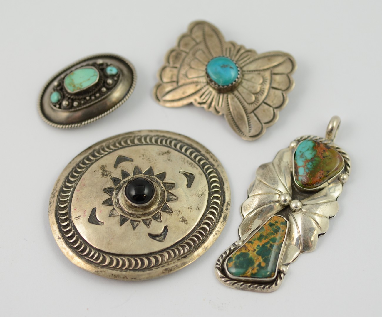 Appraisal: Navajo sterling brooches pendants stampwork turquoise etc some marked largest