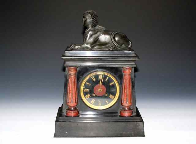 Appraisal: A VICTORIAN 'EGYPTIAN REVIVAL' BLACK SLATE MANTEL CLOCK with striking