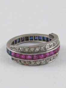 Appraisal: A diamond ruby and sapphire eternity ring the swivel diamond