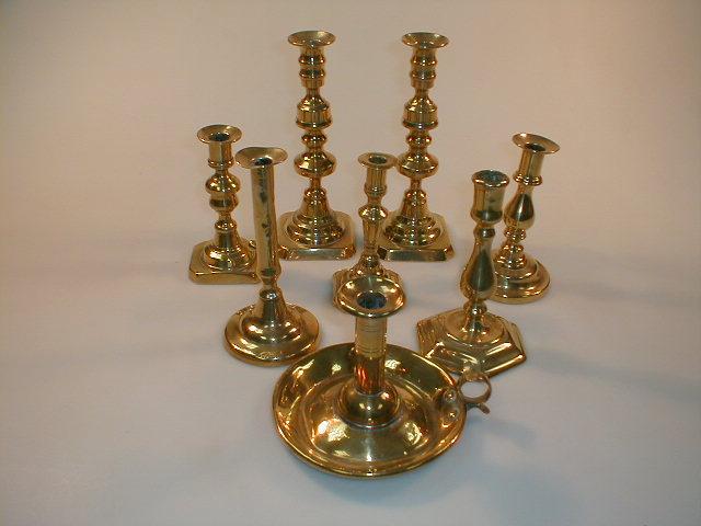 Appraisal: An thC brass candlestick with a plain stem with protruding