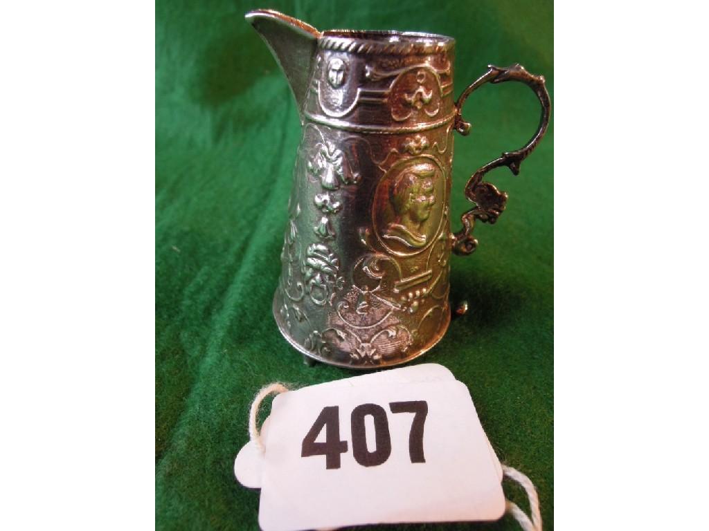 Appraisal: A small silver cream jug with three embossed profiles within