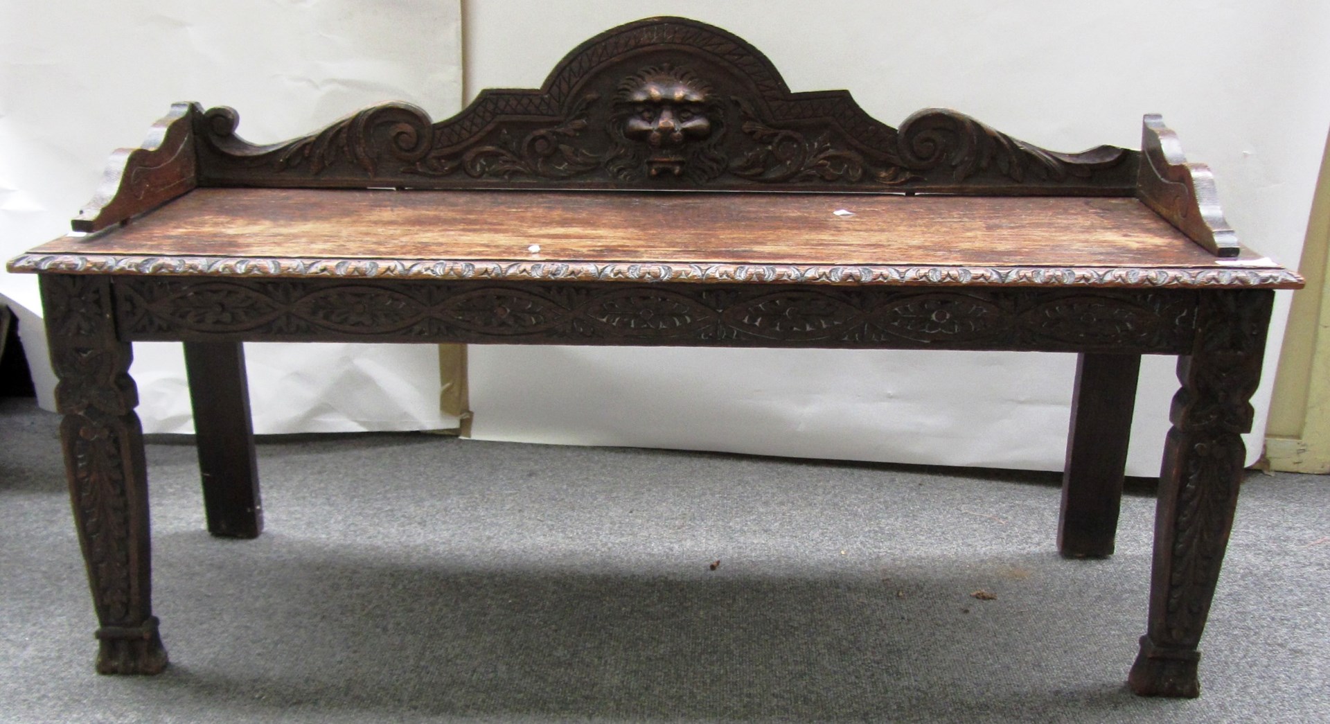 Appraisal: A Victorian carved oak hall bench with lions head mount