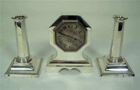 Appraisal: An art deco silver cased desk clock and candlesticks Birmingham