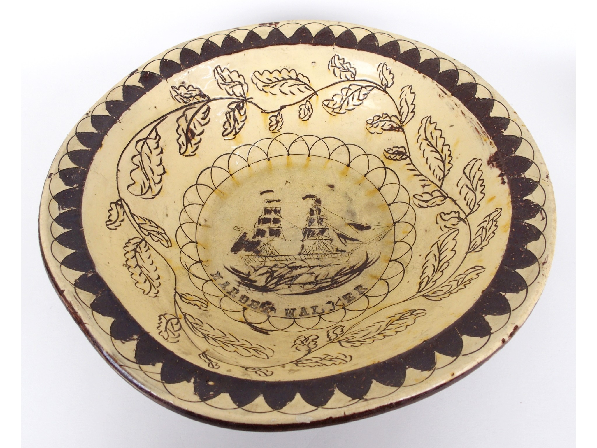 Appraisal: A rare slipware bowlSgraffiato decorated with a British ship and