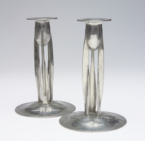 Appraisal: STYLE OF ARCHIBALD KNOX Pair of pewter candlesticks each with