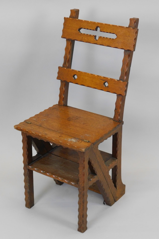 Appraisal: A Victorian carved oak Gothic style metamorphic library chair with