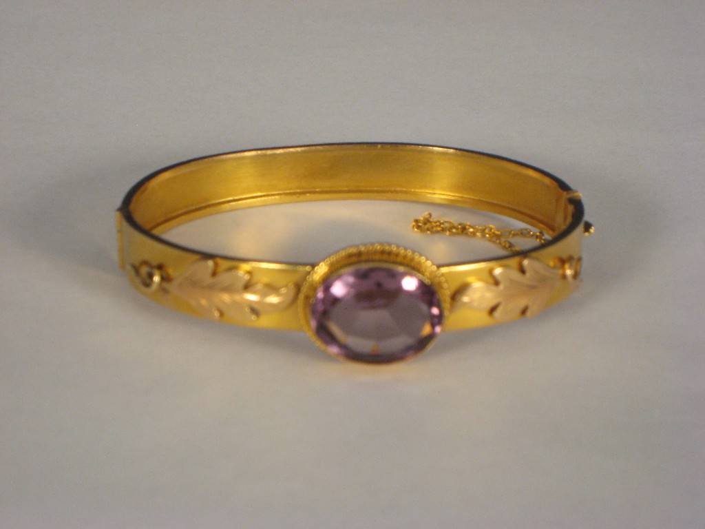 Appraisal: A gold Bangle set oval amethyst flanked by leafage design