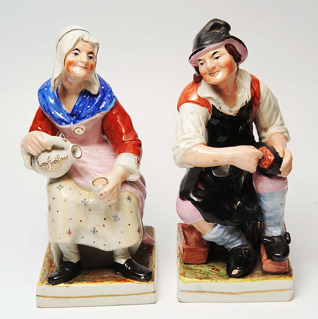 Appraisal: A PAIR OF LARGE STAFFORDSHIRE FIGURINES The cobbler and his