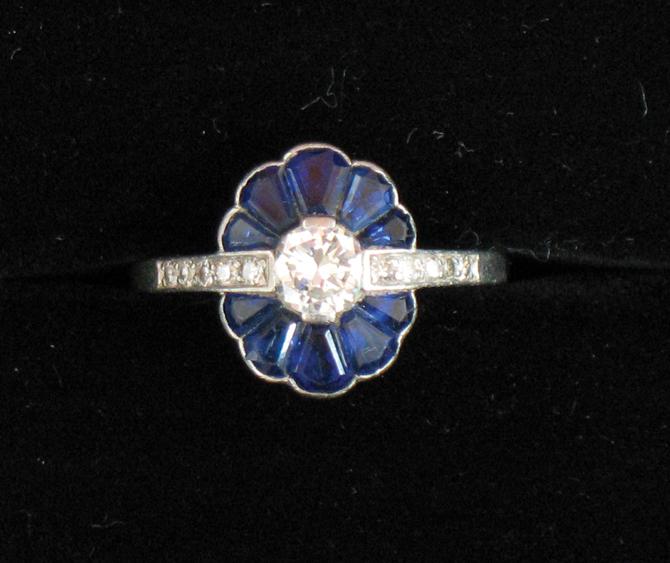 Appraisal: A SAPPHIRE AND DIAMOND DRESS RING the central round brilliant-cut